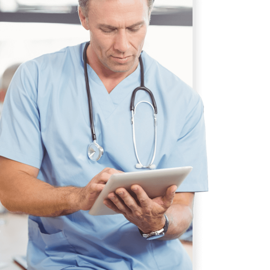 A surgeon works on a mobile tablet, likely an iPad