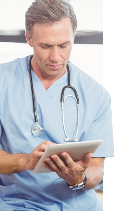 A surgeon works on a mobile tablet, likely an iPad